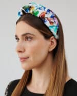 Side perspective of a woman wearing the Maria Blueberry Headband, emphasizing the headband's structure and colorful design.