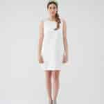 Elegant model in a Maria Daisy Mini Dress paired with the vibrant Tulip Headband, standing confidently in blue ankle-strap heels against a white backdrop.