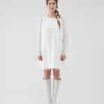 Model wearing an off-white lace Maria Lily Mini Dress with silk satin details and mini sequins embroidery, complemented by a colorful Lemon Headband and white knee-high boots