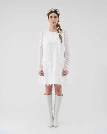Model wearing an off-white lace Maria Lily Mini Dress with silk satin details and mini sequins embroidery, complemented by a colorful Lemon Headband and white knee-high boots