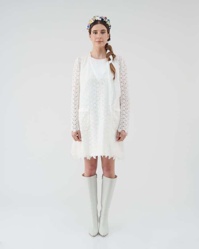 Model wearing an off-white lace Maria Lily Mini Dress with silk satin details and mini sequins embroidery, complemented by a colorful Lemon Headband and white knee-high boots