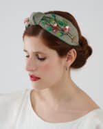 Elegant Greenery Headband hand-embroidered with green leaves, pink flowers, and sequins, displayed on a model wearing the Maria Jasmine Mini Dress.