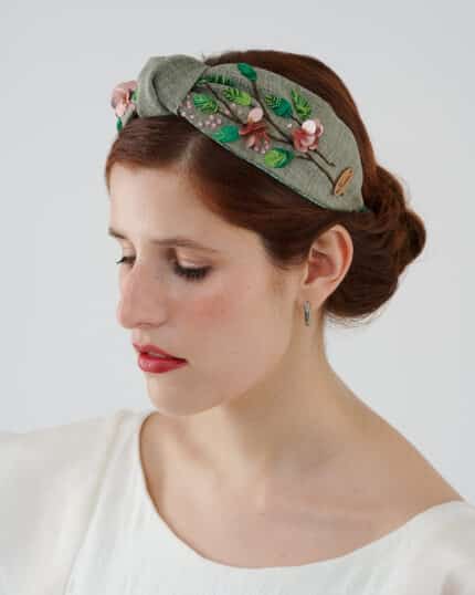 Elegant Greenery Headband hand-embroidered with green leaves, pink flowers, and sequins, displayed on a model wearing the Maria Jasmine Mini Dress.