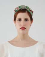 Frontal view of a model wearing the hand-embroidered Greenery Headband adorned with cotton floss and sequins, paired with the delicate Maria Jasmine Mini Dress.